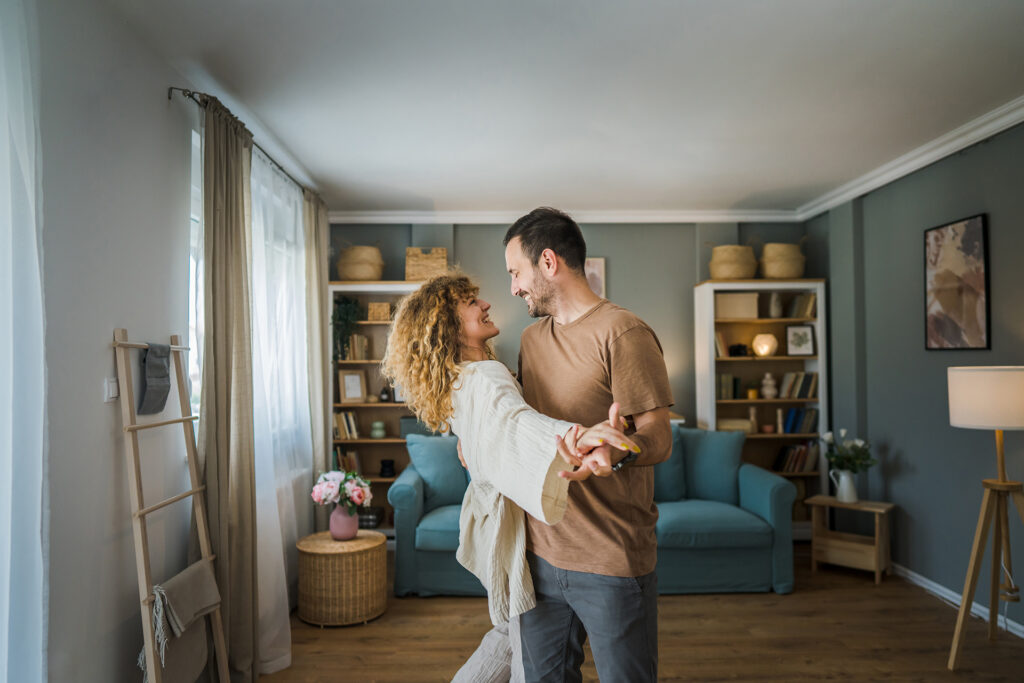 Couple dancing in living room