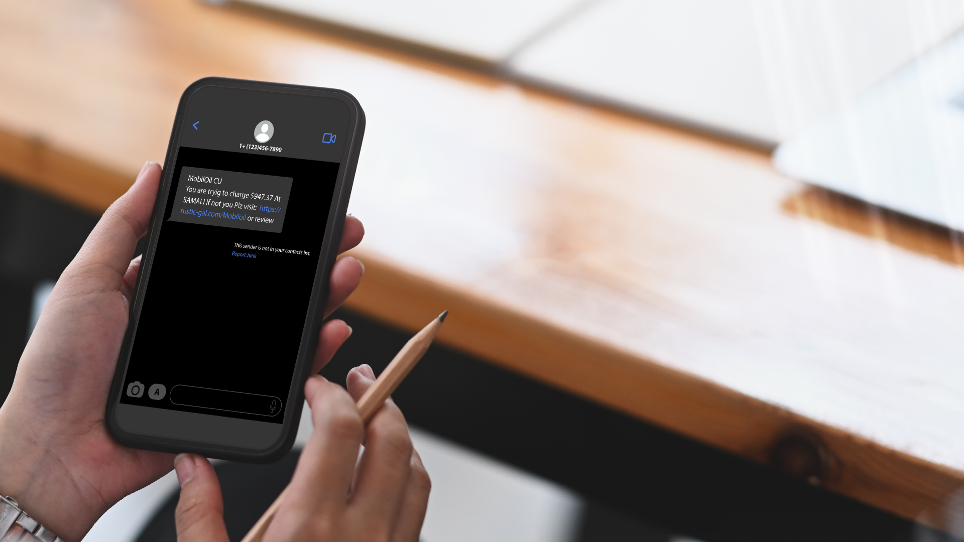 Someone reading a fraudulent text message on phone.