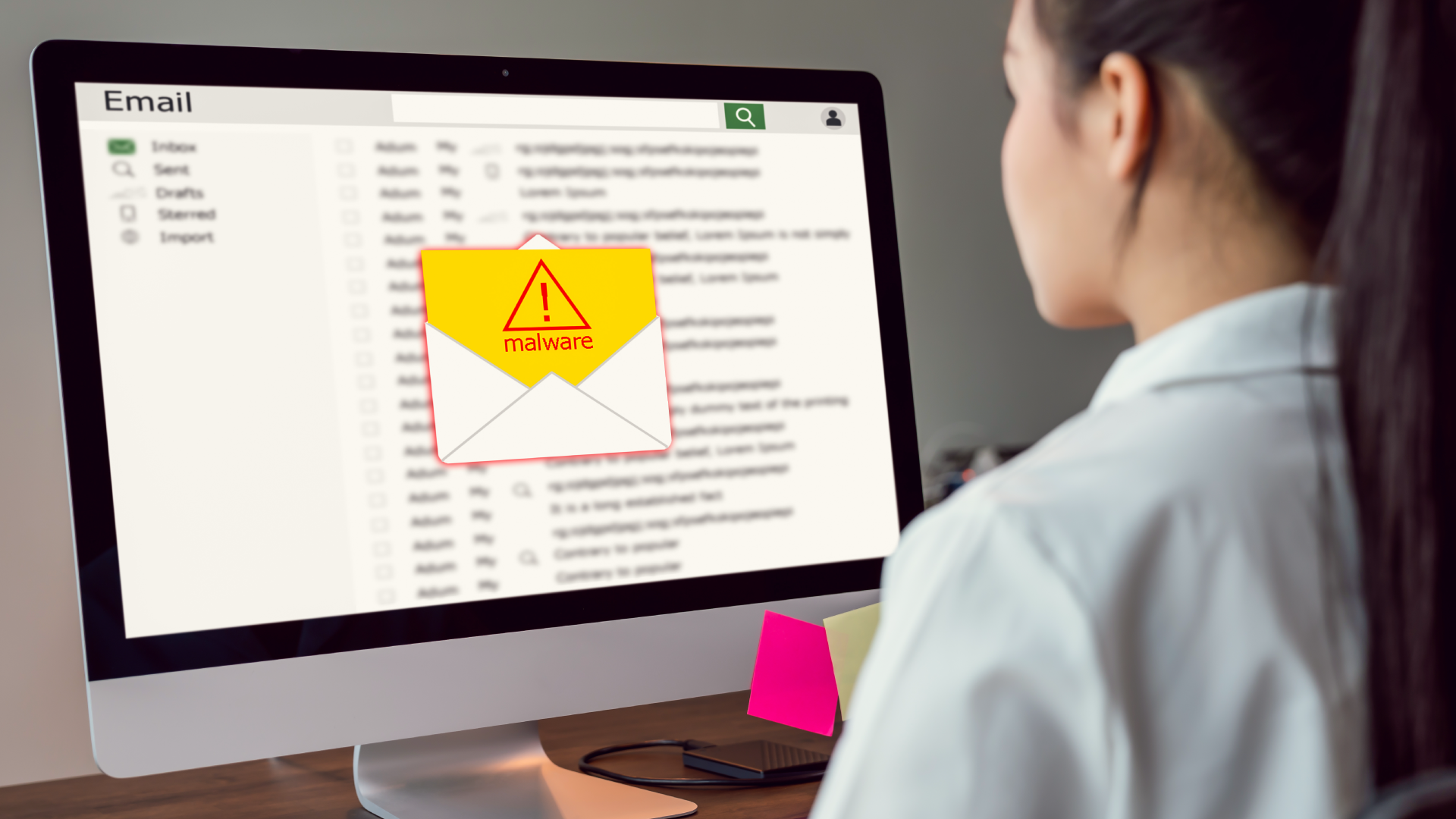 Someone reading a fraudulent email on laptop.