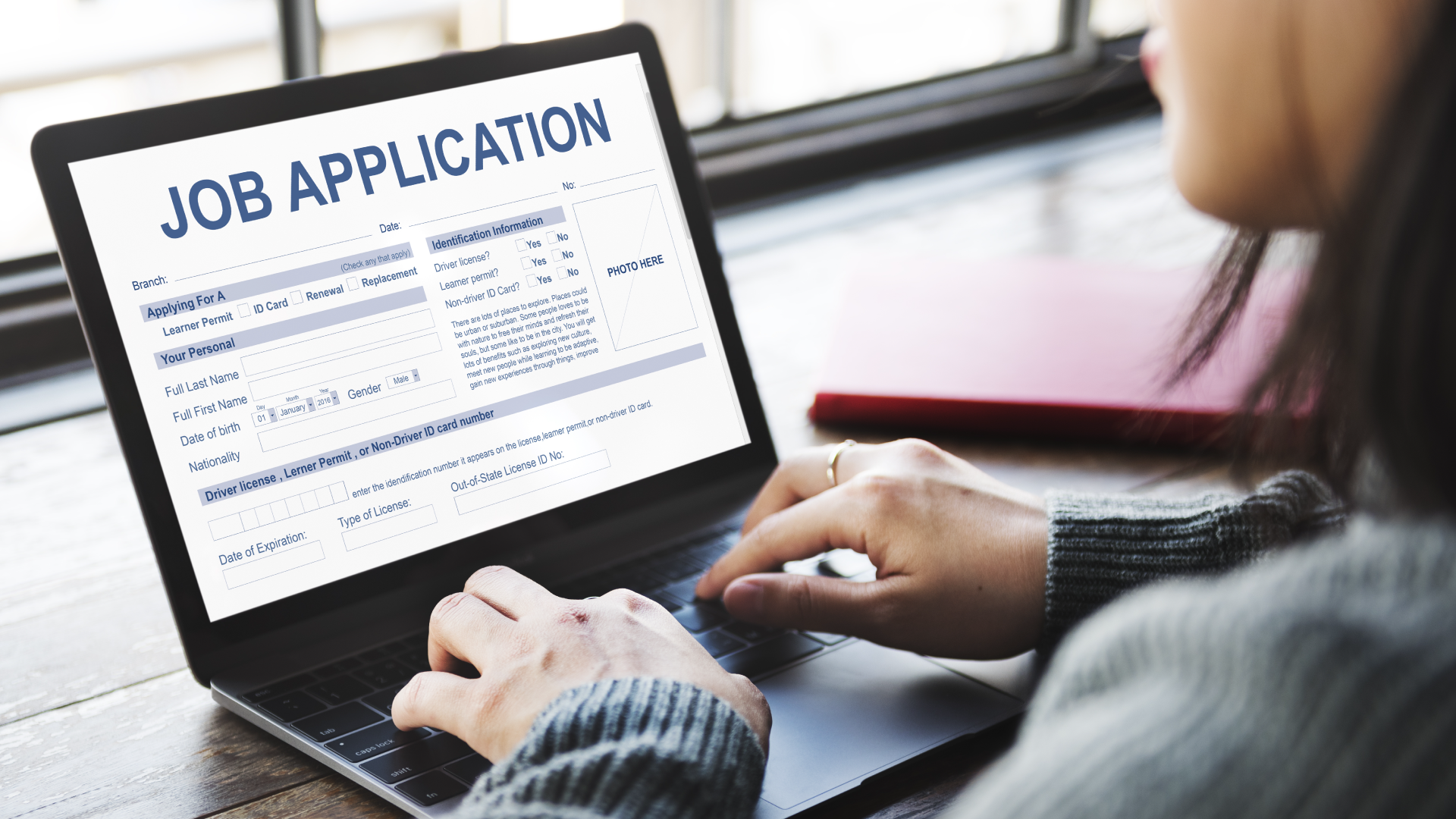 Someone filling out a job application on a laptop.