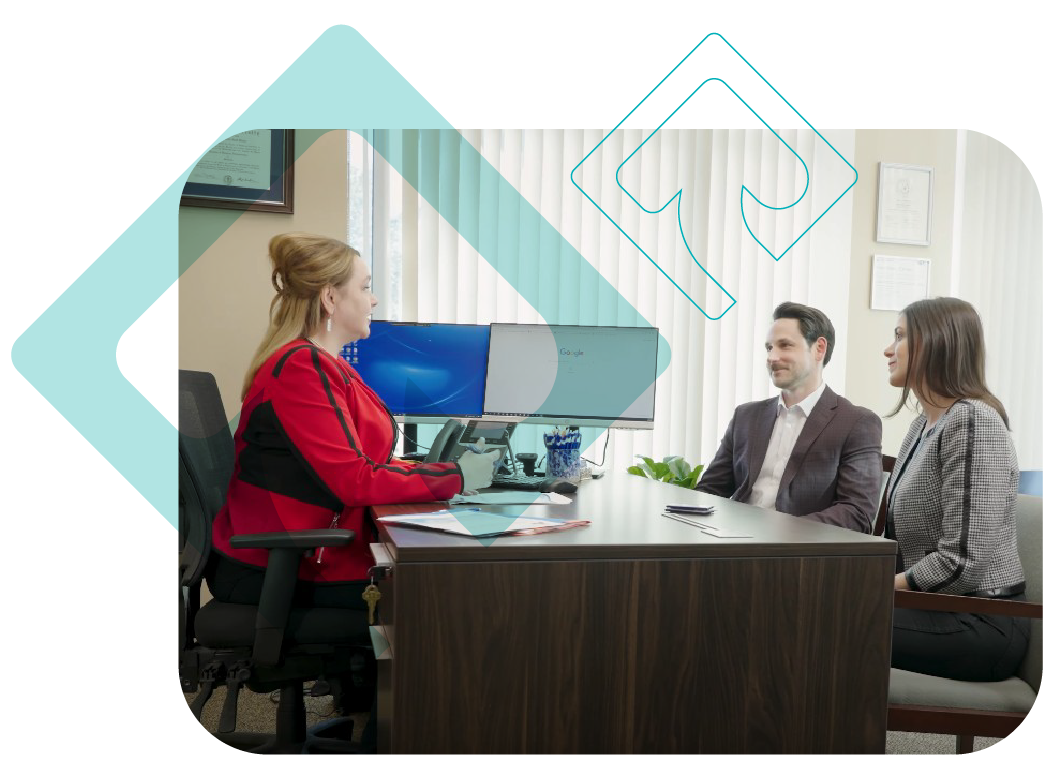 Mario Gibson, Financial Advisor with Osaic at Rave Financial talking to two clients in her office