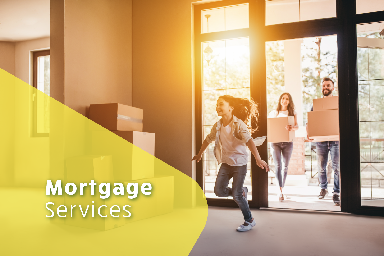 Photo of family carrying moving boxes into their new home where a young girl is running and smiling while the sun sets through the window behind her. Mortgage Services