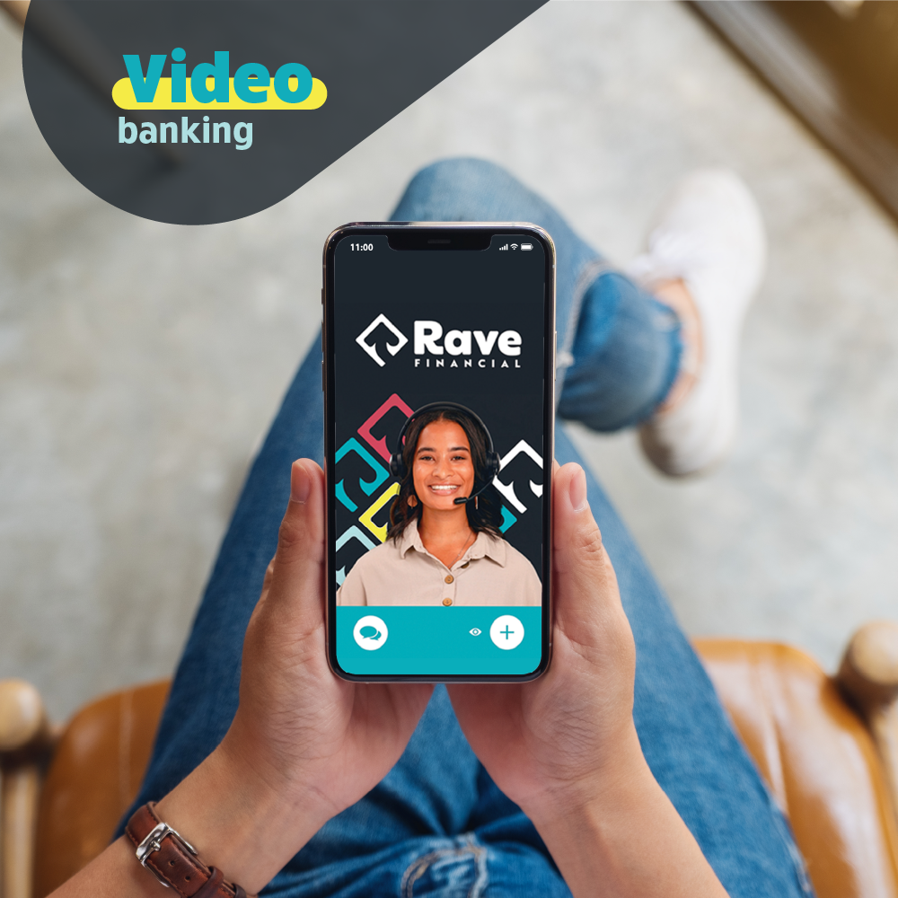 Photo of someone holding their mobile phone and speaking with a Rave Financial Credit Union Representative, taken from above someone's lap