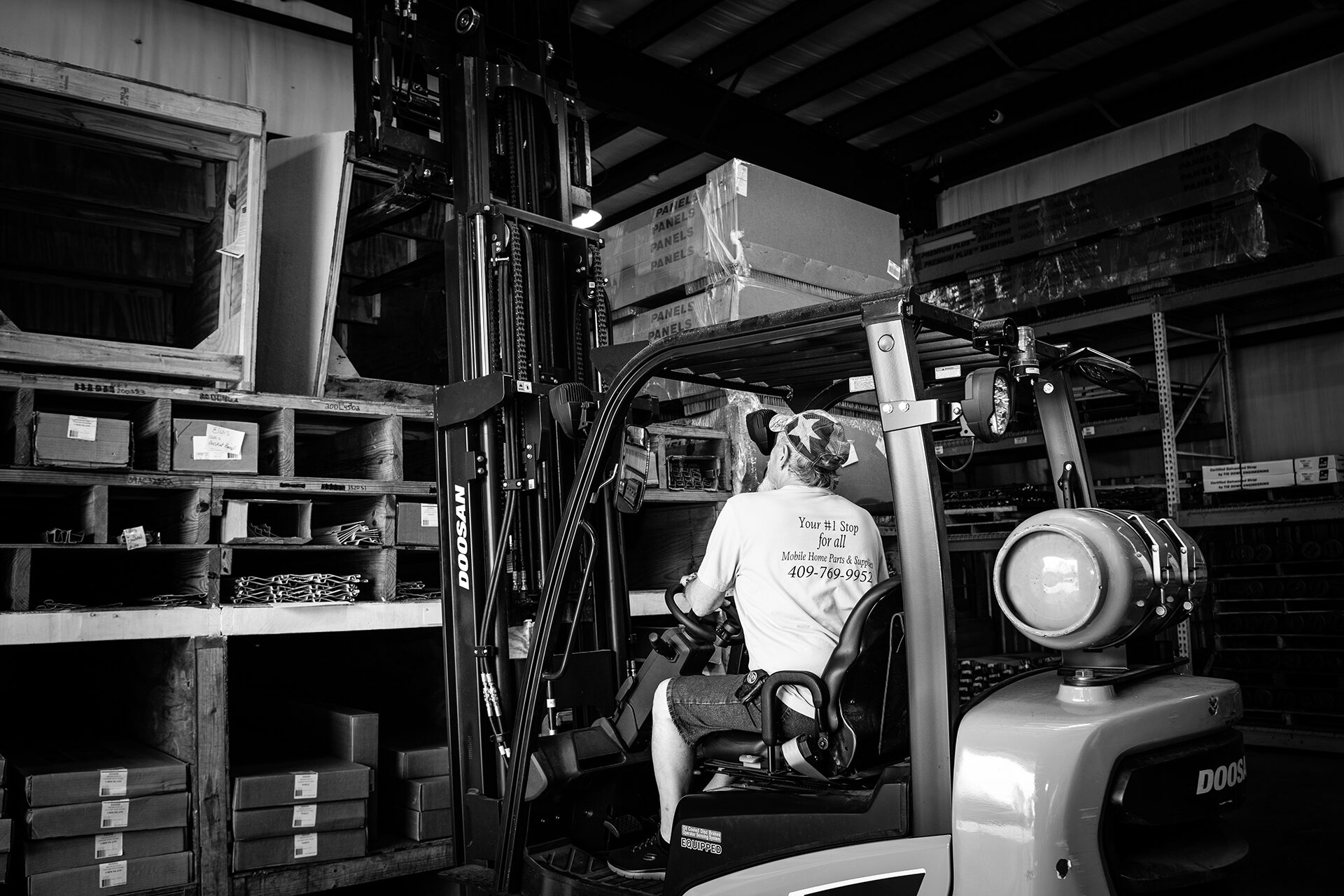 Parts House business Employee using a forklift to lift boxes
