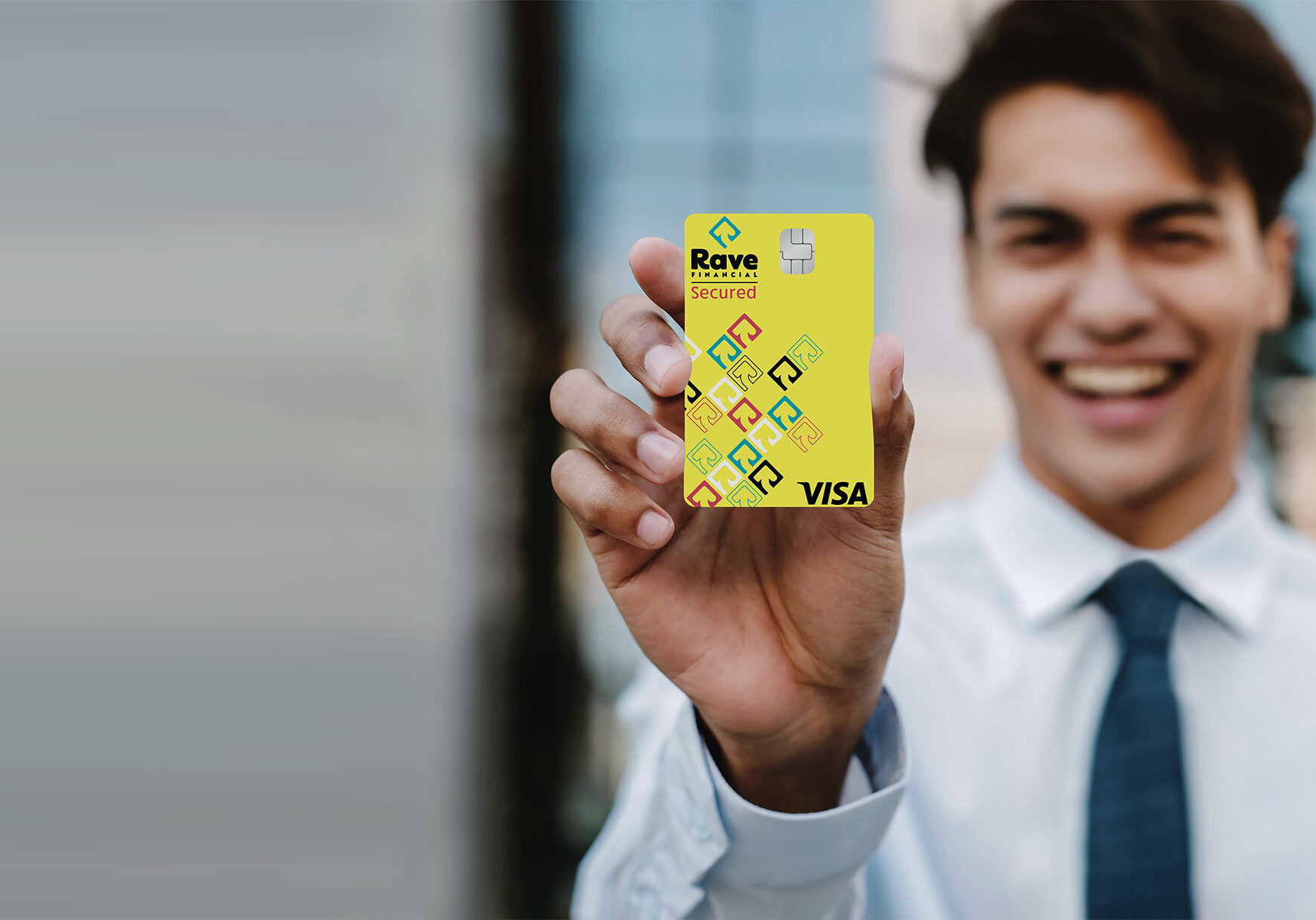 young guy holding Rave Financial Secured Credit Card
