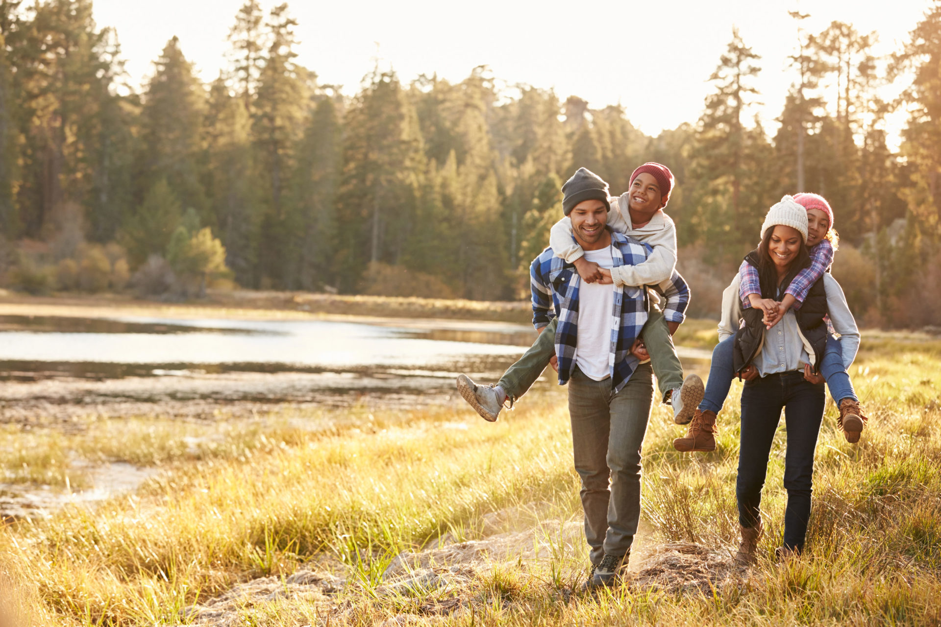 family hiking along river