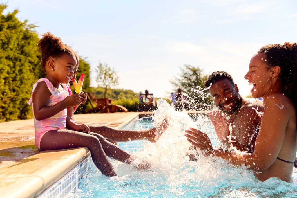 family splashing in pool WEB