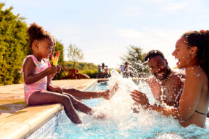 family splashing in pool WEB