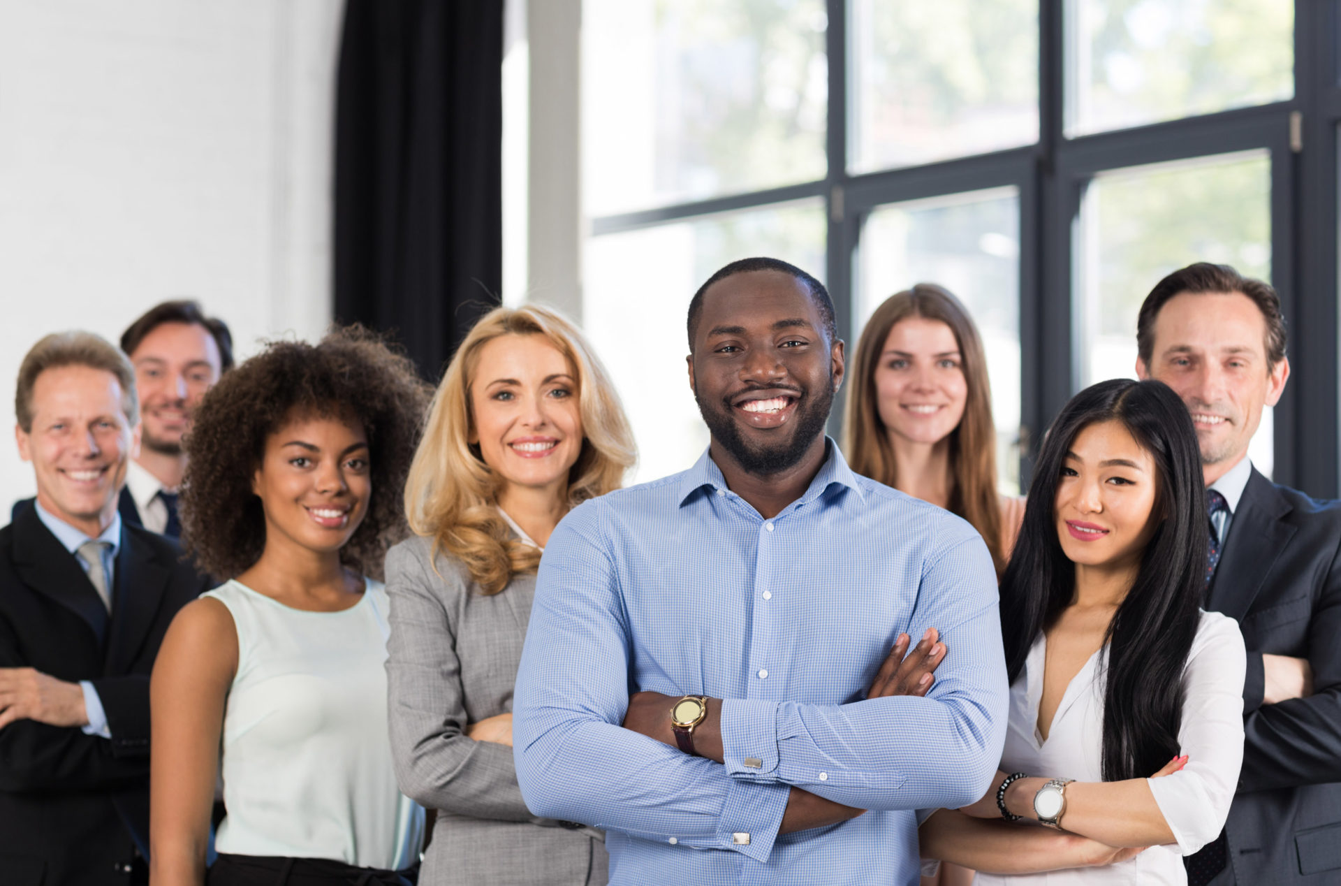 group of employees standing together smiling