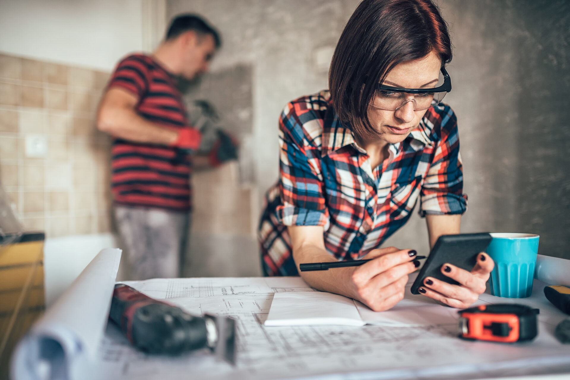 girl looking at floorplans in new home