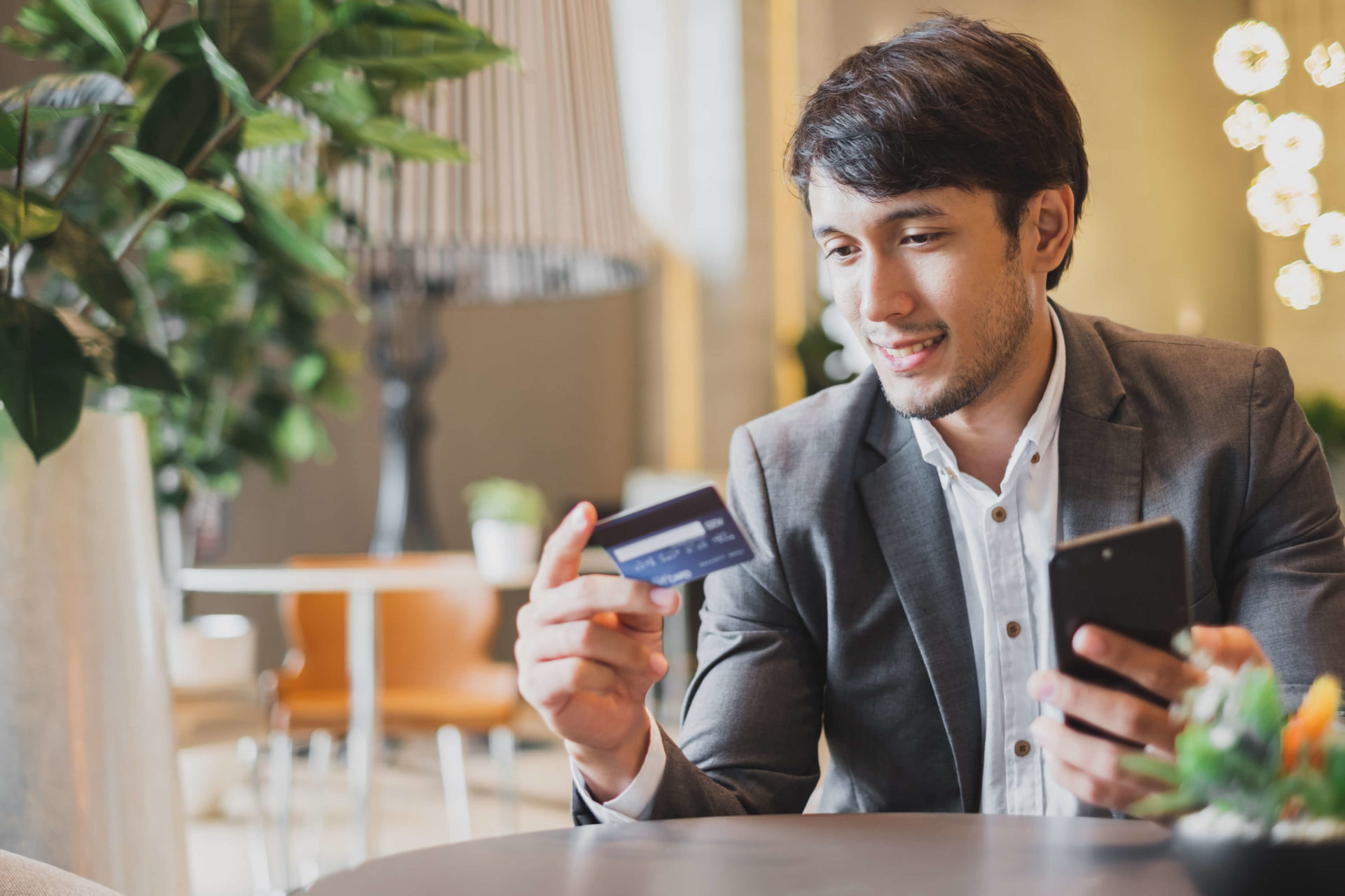 man looking at credit card